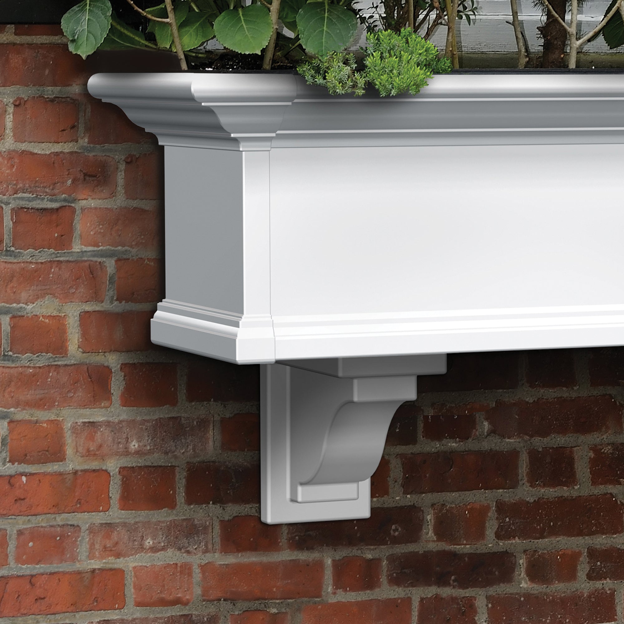 White wall-mounted Yorkshire planter with green plants against a brick wall